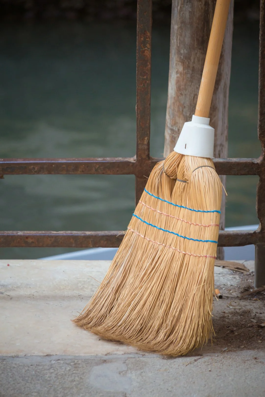 A black-and-white image showing a person mopping the floor in a contemporary living room.